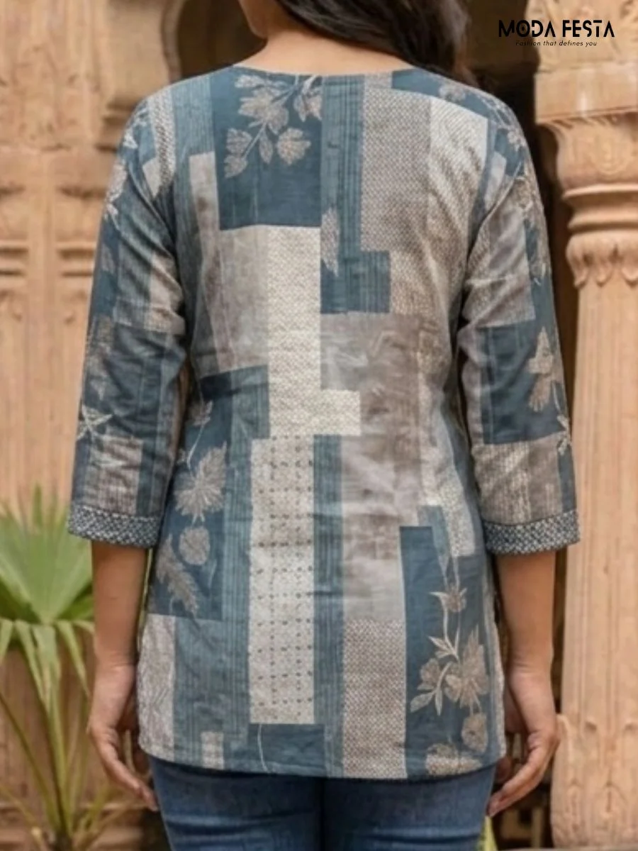 This stylish blue kurti features a unique patchwork-inspired print that blends floral and geometric patterns for a modern take on traditional ethnic wear.