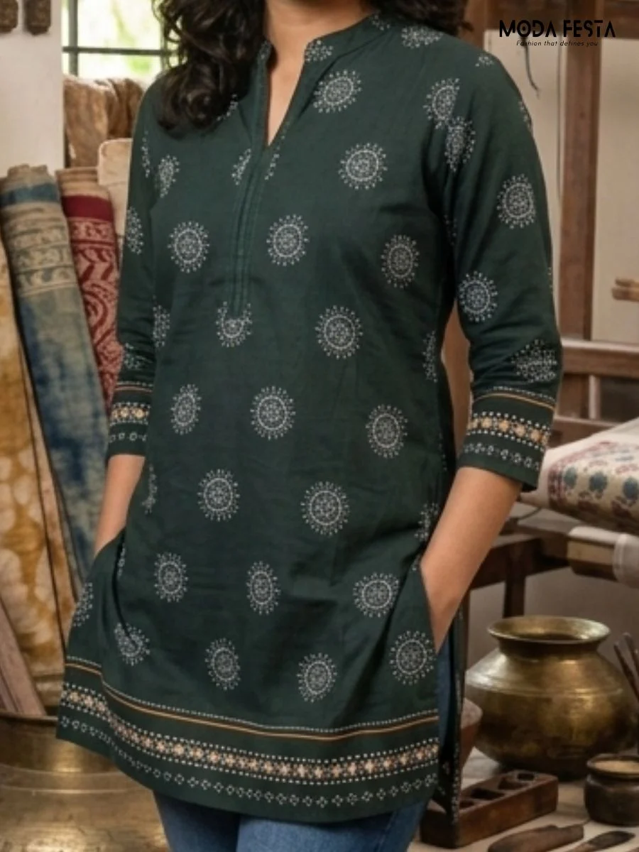 This elegant bottle green short kurti features intricate circular mandala-inspired motifs and a detailed contrast border, making it a perfect blend of traditional charm and contemporary style.