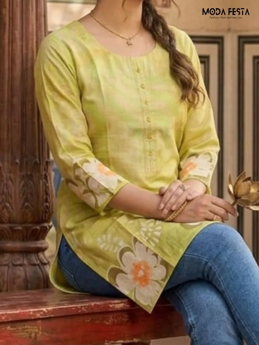 This vibrant lime green short kurti features bold white and orange floral motifs, offering a fresh and cheerful style for everyday ethnic wear.