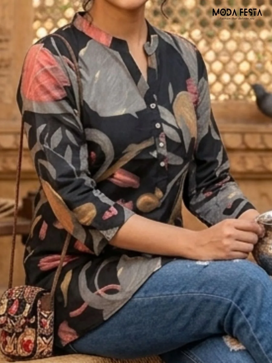 This sophisticated short kurti features a dark base adorned with an elegant, muted botanical floral print and is styled with a classic mandarin collar.