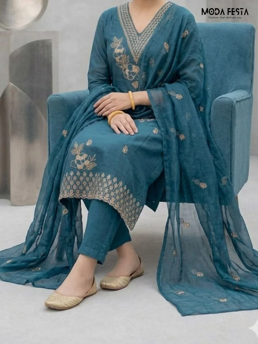 This sophisticated teal co-ord set features elegant gold thread embroidery on the neckline and kurta, paired with a matching sheer dupatta for a refined look.