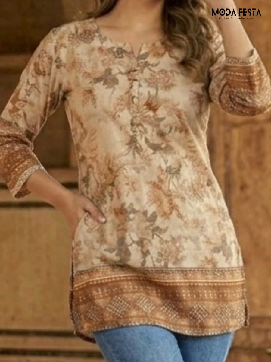 This beige tunic features an elegant floral print with a distinctive patterned border, blending traditional charm with a comfortable, modern silhouette.