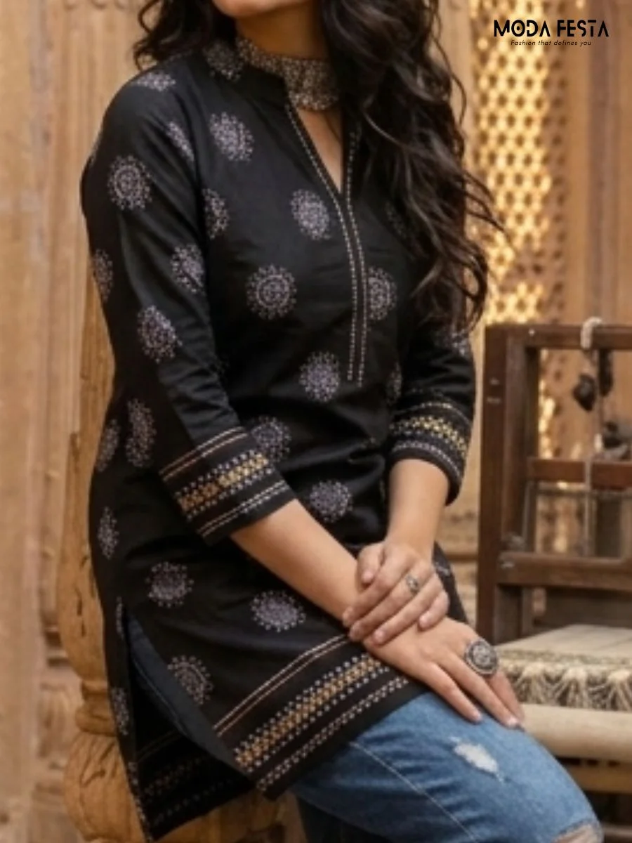 This striking black kurti features a sophisticated mandala-inspired circular print, perfectly complemented by a detailed contrast border and a refined, elegant neckline.