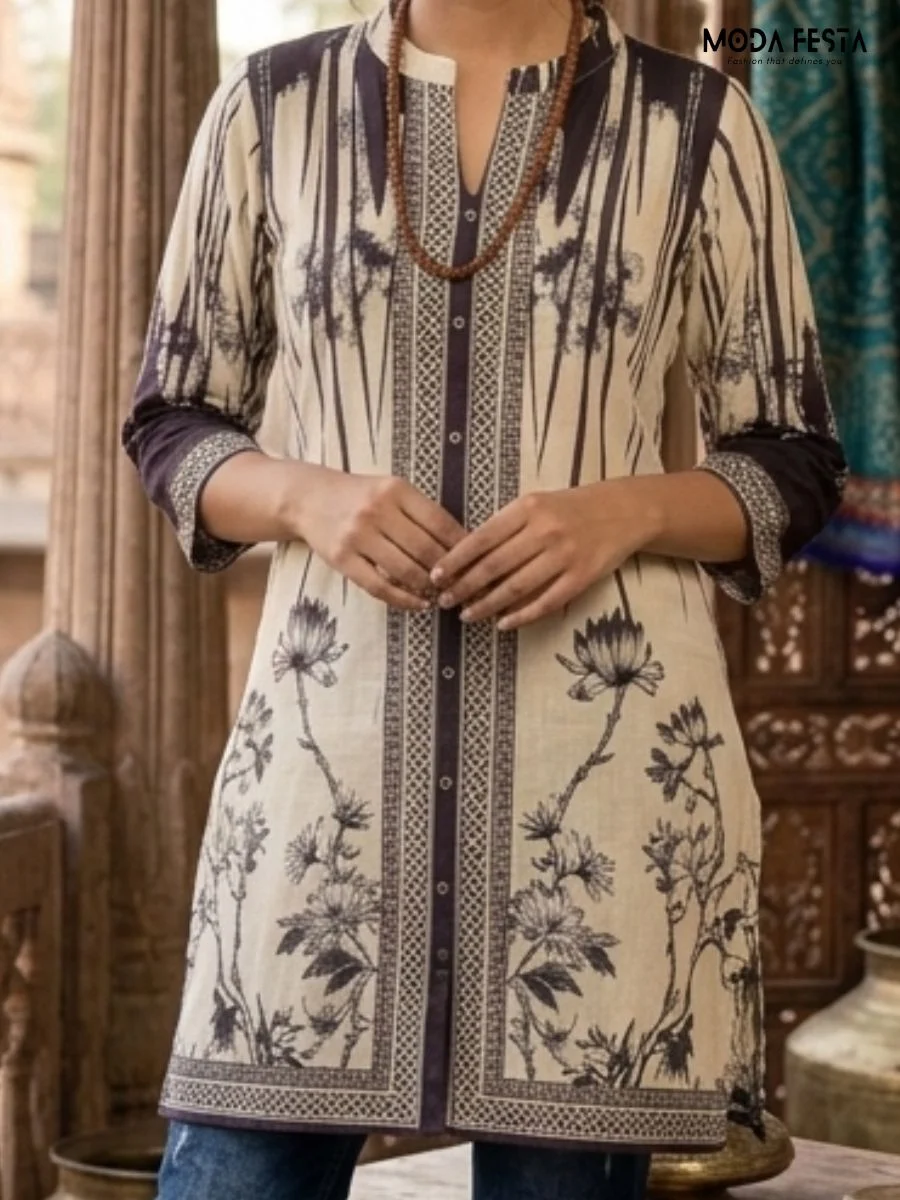 This sophisticated monochromatic kurti features an artistic blend of bold floral prints and intricate geometric paneling, accented by a refined mandarin collar.