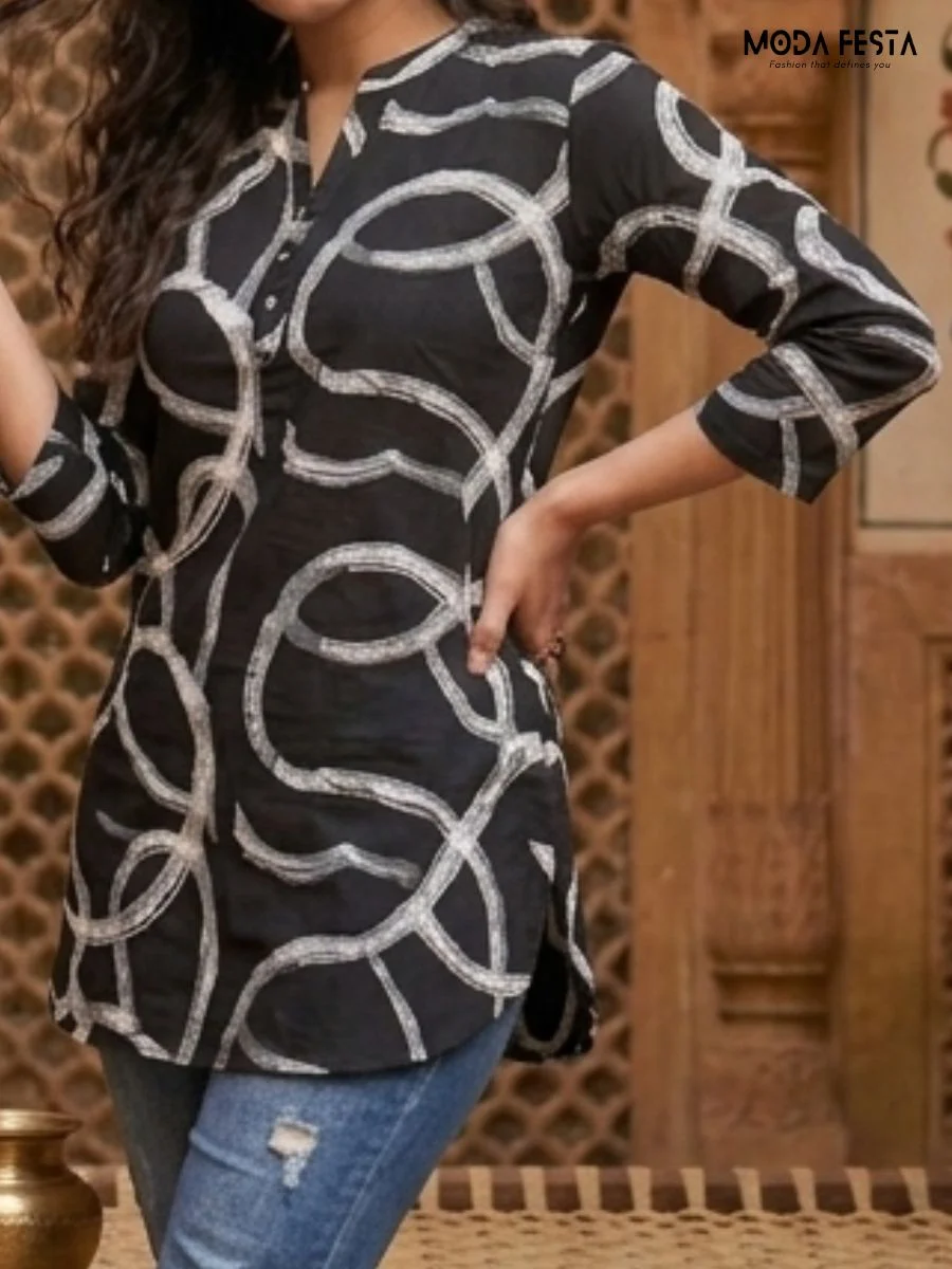 This stylish short kurti features a bold, monochrome abstract print on breathable cotton with a classic mandarin collar and button-down placket.