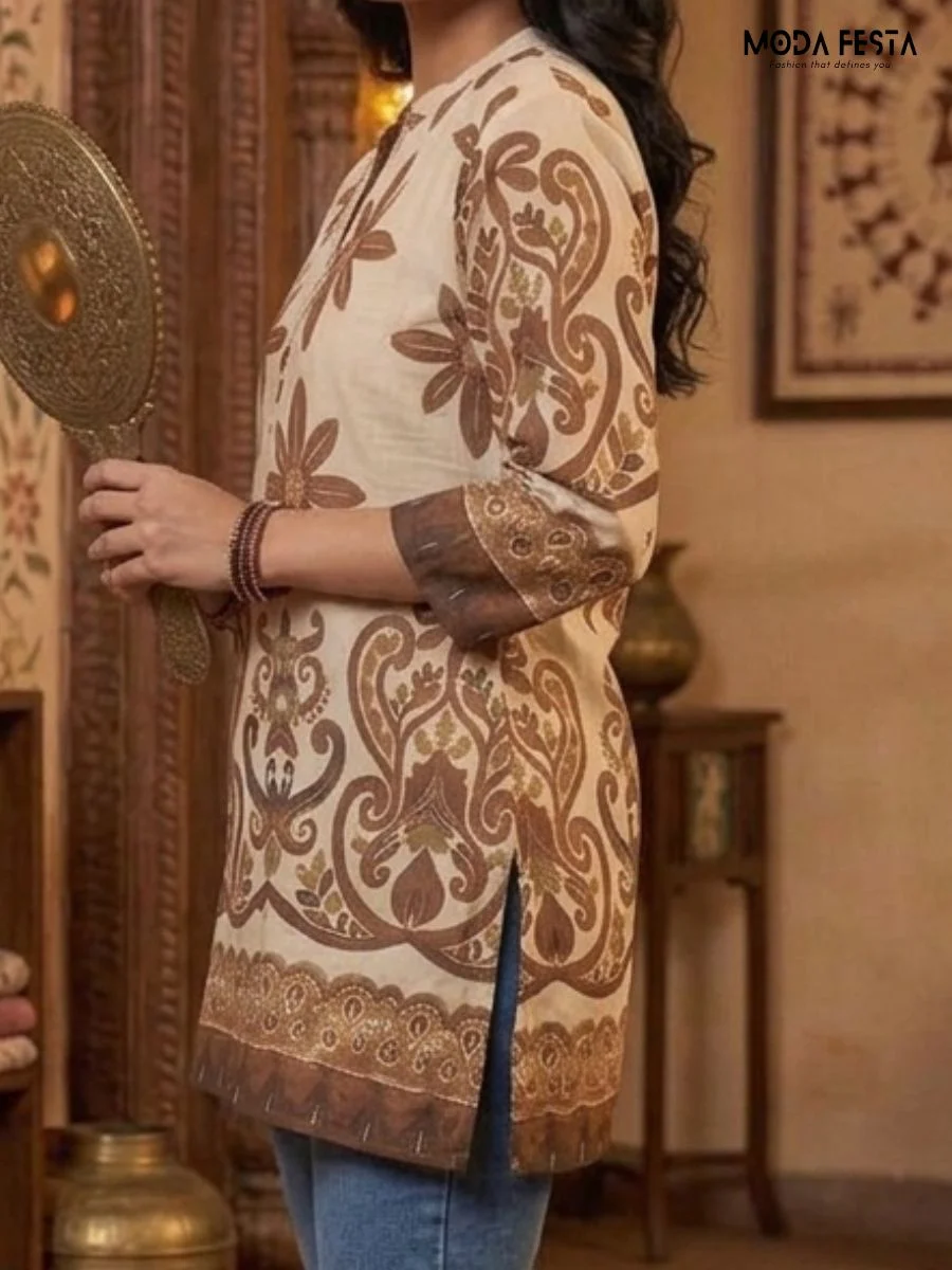 This elegant, cream-colored tunic features a bold brown floral and ethnic-inspired print, perfectly blending traditional artistry with a contemporary silhouette for a sophisticated look.