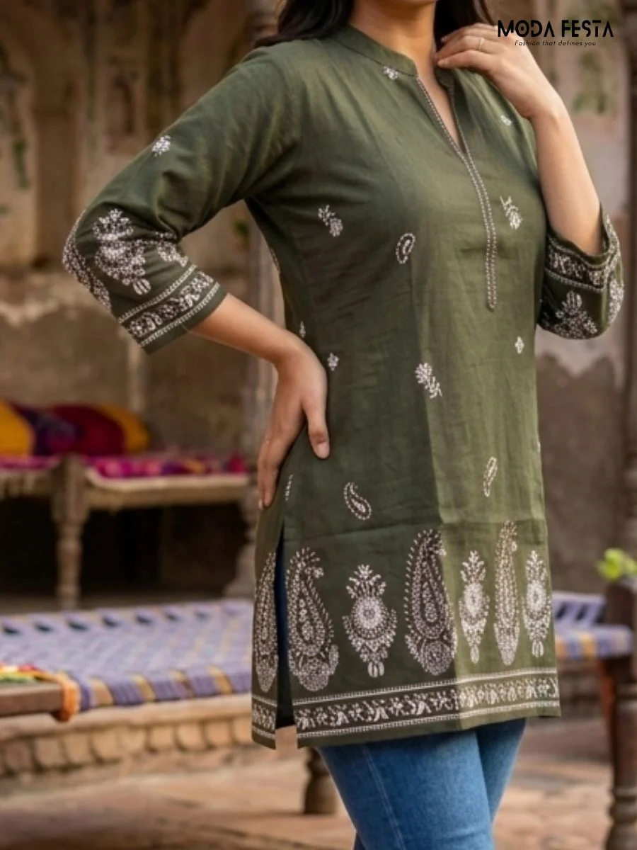 This sophisticated olive green kurti features intricate white paisley embroidery and a classic mandarin collar, offering a refined blend of traditional aesthetics