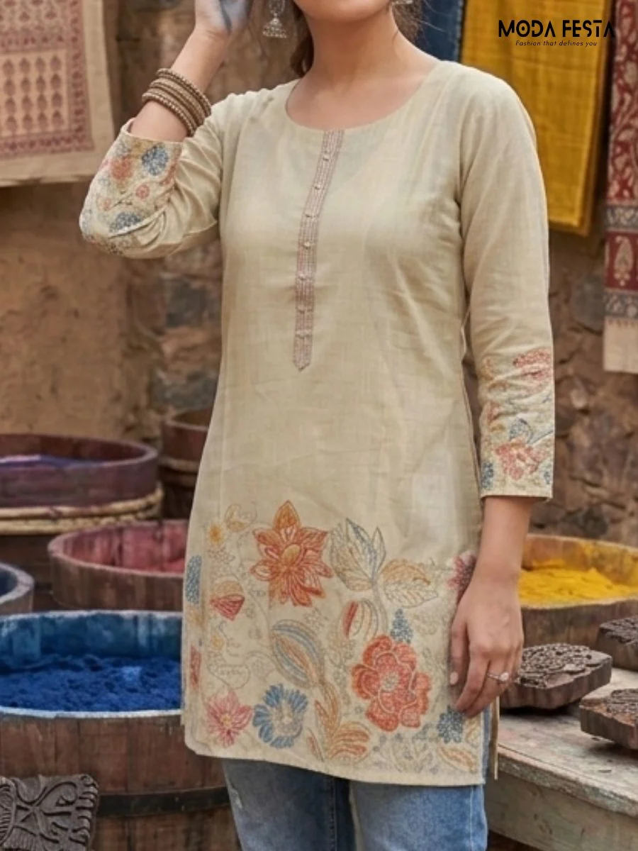 This elegant beige kurti features a delicate, multi-colored floral print along the hem and sleeves, offering a graceful and versatile choice for daily ethnic wear.