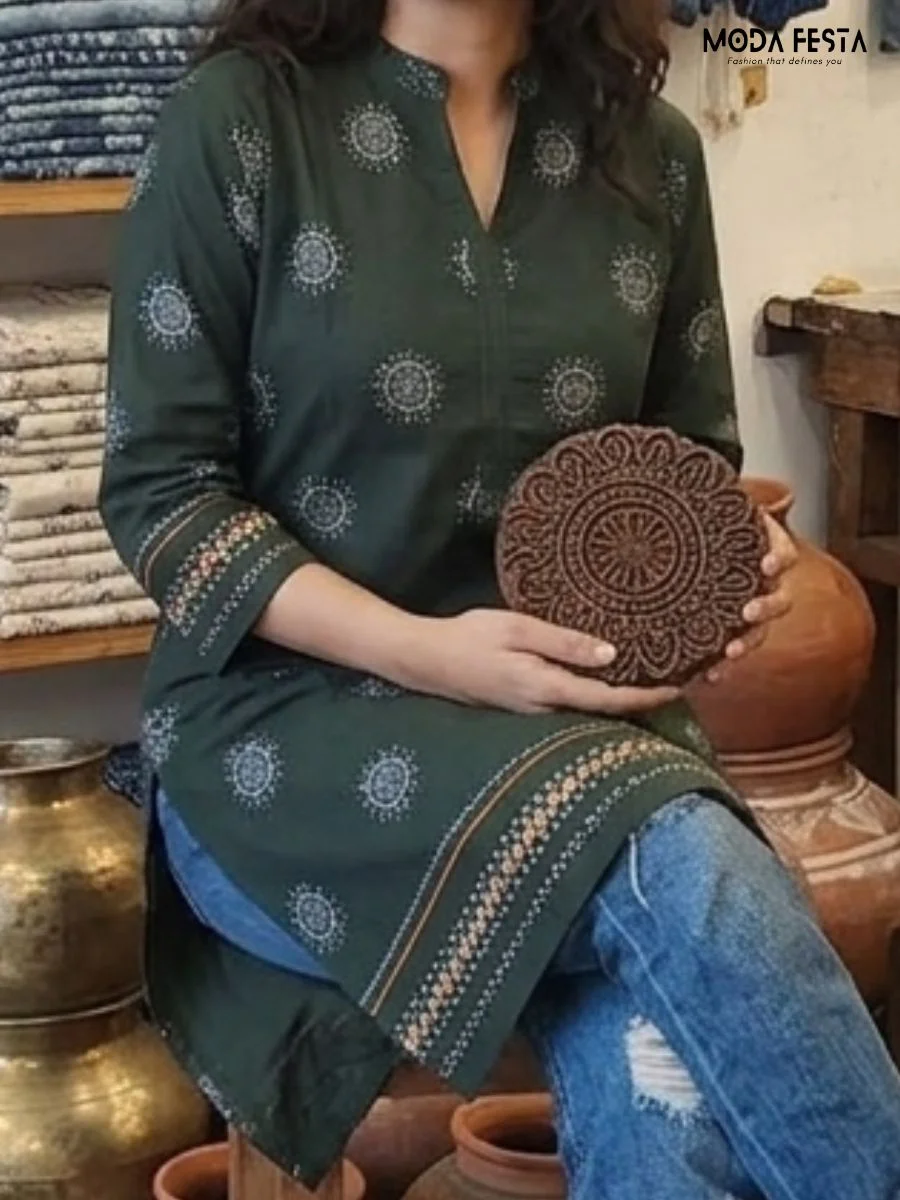 This elegant bottle green short kurti features intricate circular mandala-inspired motifs and a detailed contrast border, making it a perfect blend of traditional charm and contemporary style.